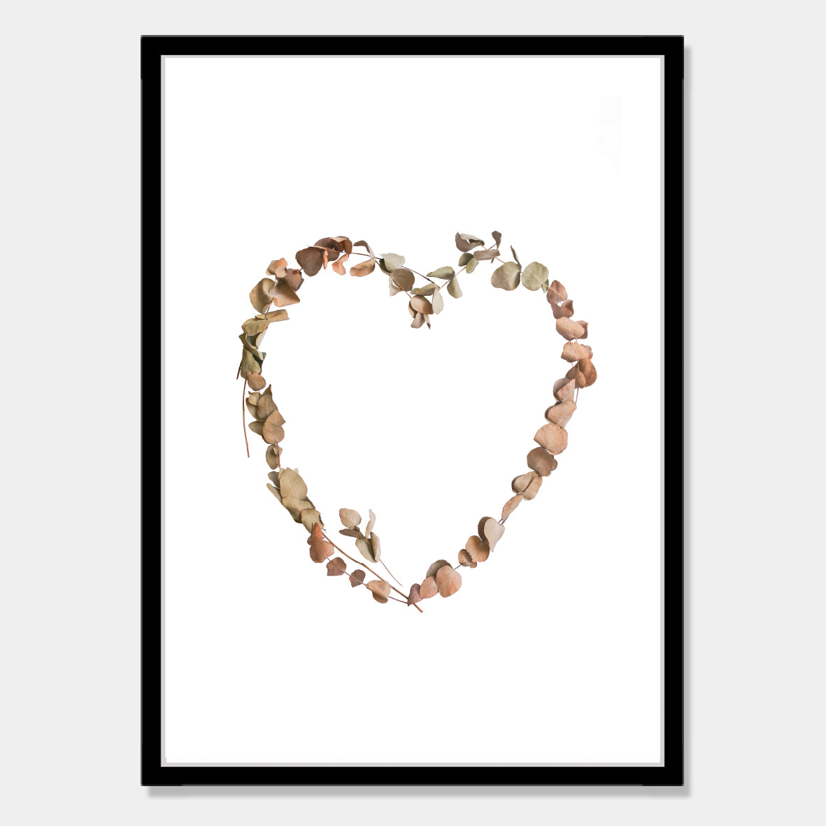 Photographic art print of dried leaves in a heart shape by Bon Jung. Printed in New Zealand by endemicworld and framed in black.