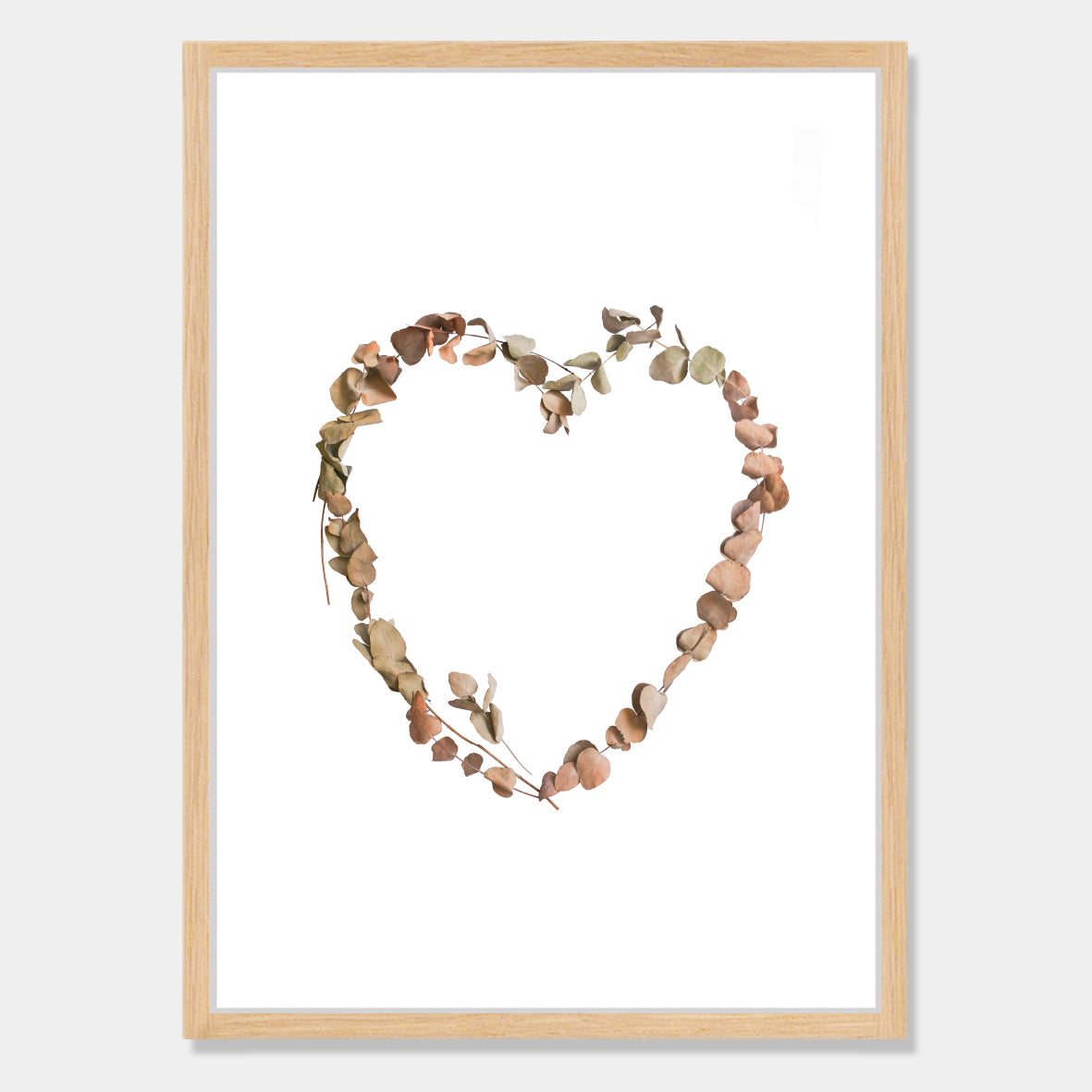 Photographic art print of dried leaves in a heart shape by Bon Jung. Printed in New Zealand by endemicworld and framed in raw oak.
