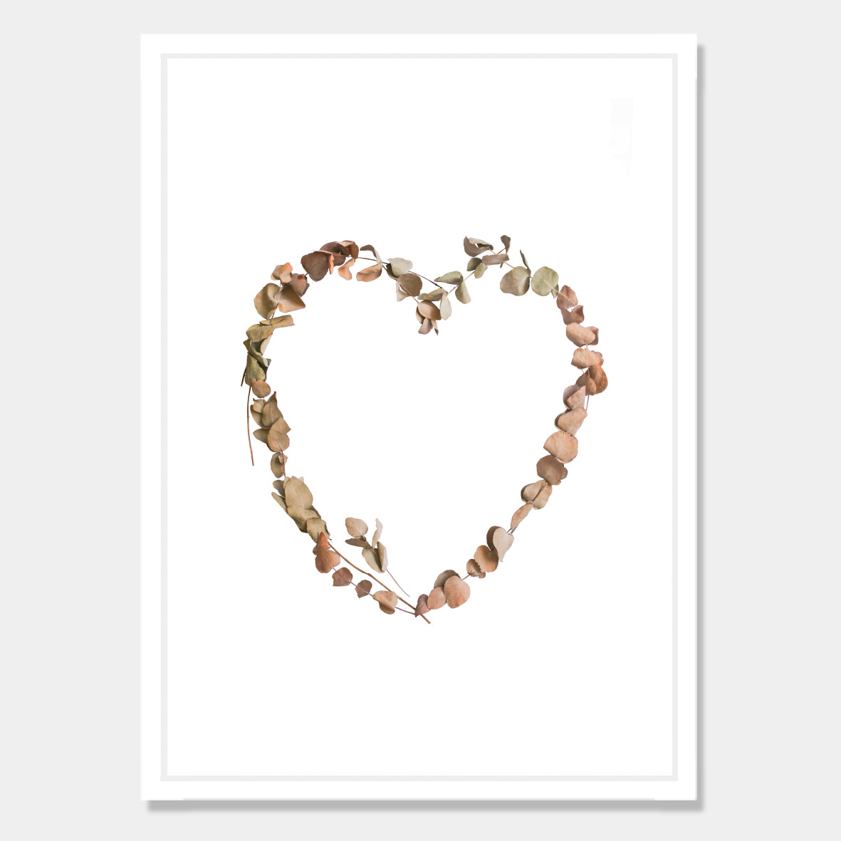 Photographic art print of dried leaves in a heart shape by Bon Jung. Printed in New Zealand by endemicworld and framed in white.