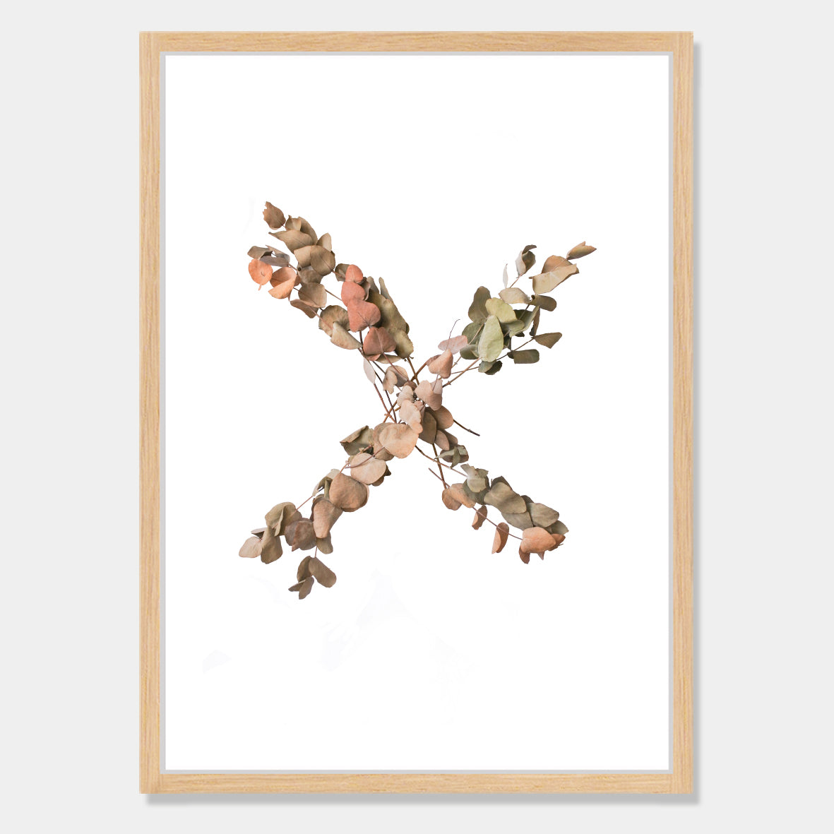 Photographic art print of dried leaves in a X shape by Bon Jung. Printed in New Zealand by endemicworld and framed in raw oak.