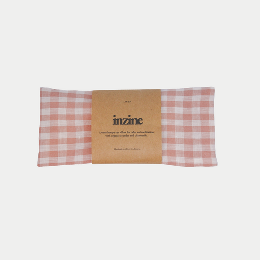 Handmade linen eye pillow in gingham blush, filled with organic chamomile and lavender and linseed.