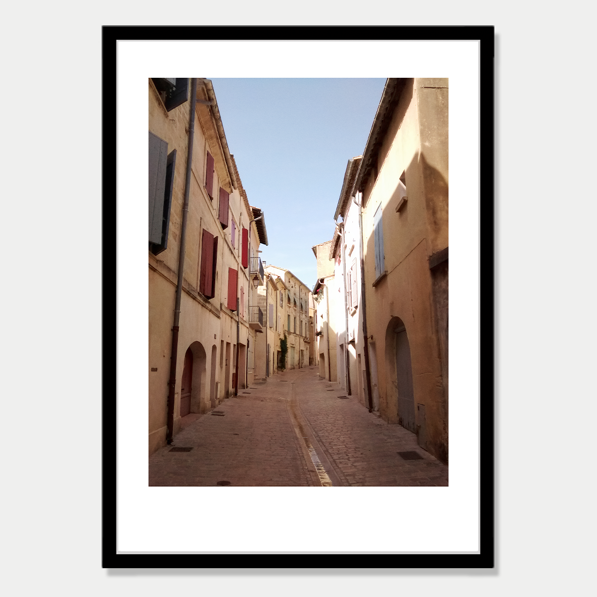 Looking down an Empty Street in Uzes, a small town in France Photographic Art Print in a Skinny Black Frame