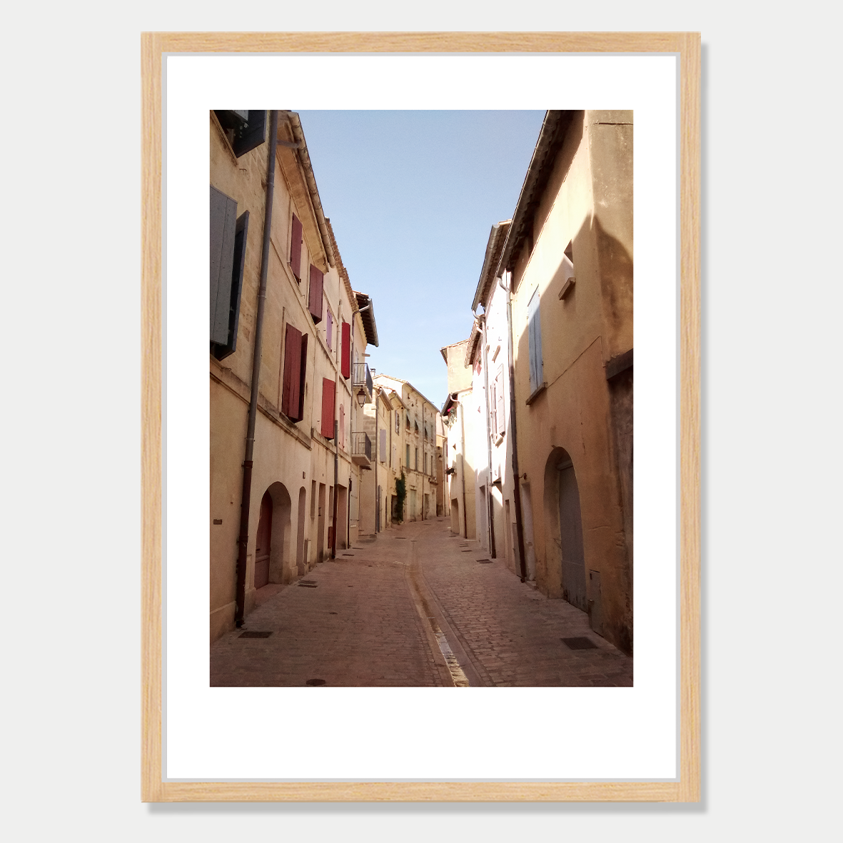 Looking down an Empty Street in Uzes, a small town in France Photographic Art Print in a Skinny Raw Wood Frame